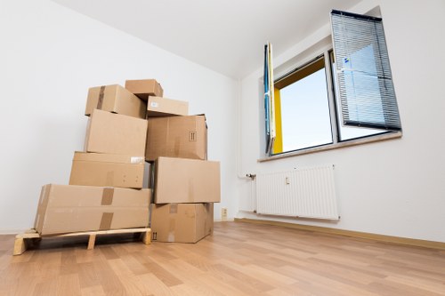 Cardboard moving boxes and packing materials prepared for a Bow home move