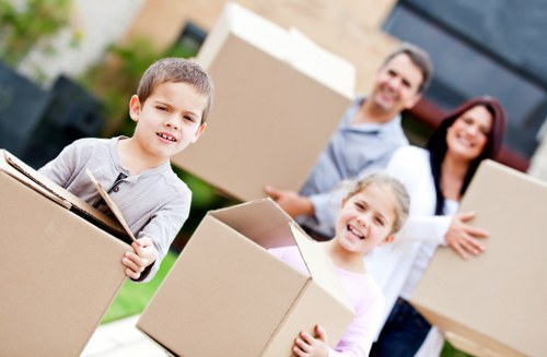 Bow movers organizing boxes and furniture during the middle of a move